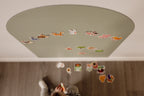 Overhead view of a toddler sorting farm magnets on the floor beneath the Wonder Arch