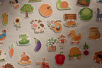 Close-up of On The Farm magnets including a cow, duck, pumpkin, sunflower and windmill
