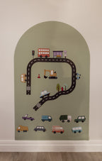 Road pieces, a bus, digger and cars arranged on the Lily Sage Wonder Arch