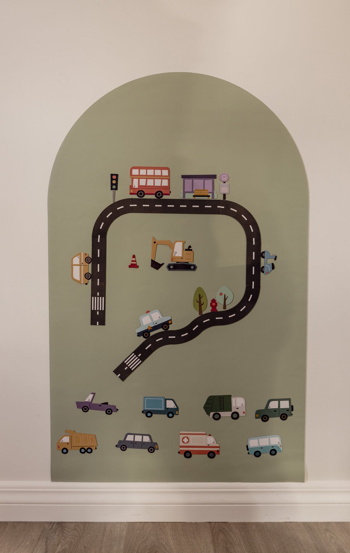 Road pieces, a bus, digger and cars arranged on the Lily Sage Wonder Arch